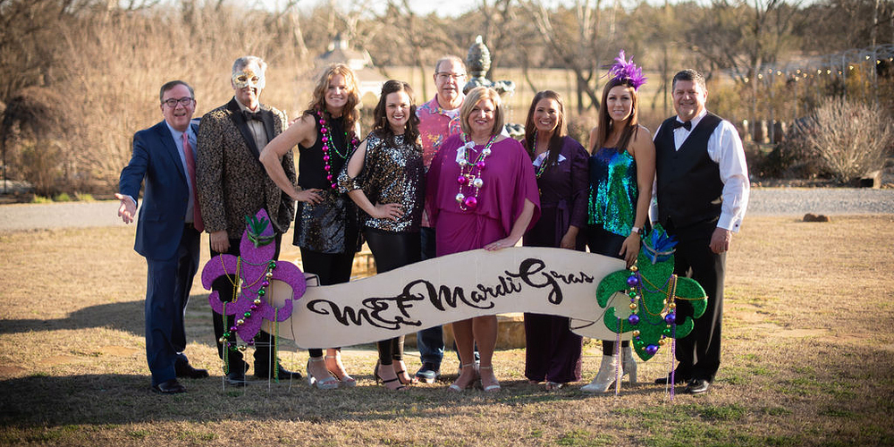 Members of the MEF board in "Mardi Gras" themed dress for the 2022 gala