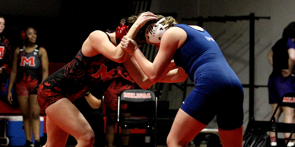 Two student-athletes compete at wrestling meet