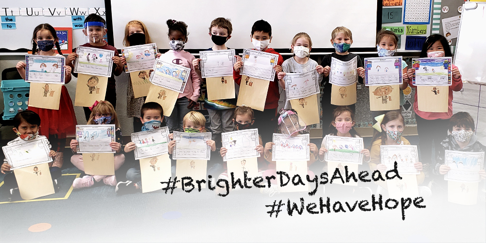 A group photo of Kindergarten students holding up their classwork with the following text overlayed: #BrighterDaysAhead #WeHaveHope
