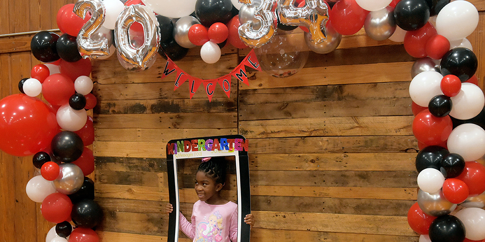 Incoming Kindergarten student poses in the Class of 2034 photobooth