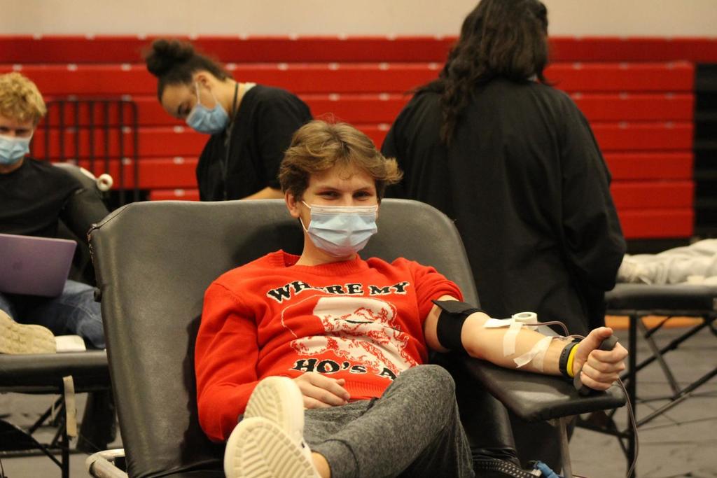 High school student donates blood at school
