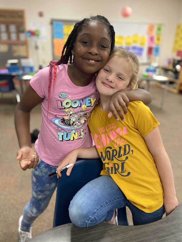 Two elementary students smile for a picture