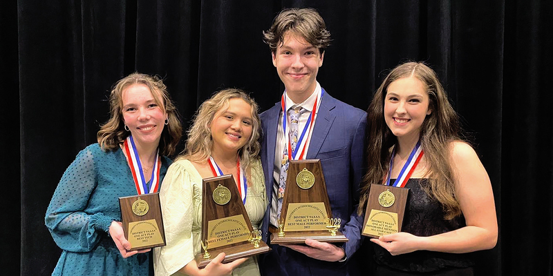 Four theatre students hold their District One Act Play trophies